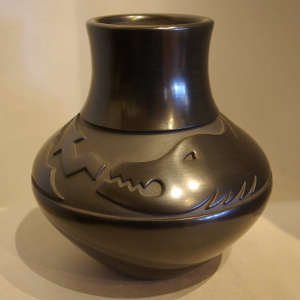Avanyu design carved into a black jar