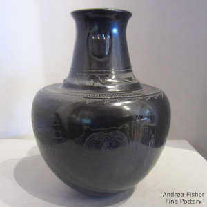 Sgraffito feather, bear, tree, bear paw, avanyu and geometric design on a black jar