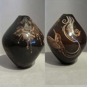 Contemporary sgraffito designs on a black jar