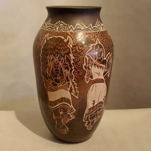 Sgraffito dancers design on a brown jar