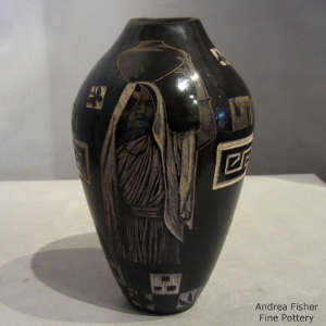 Sgraffito pueblo water carrier and geometric design on a black jar