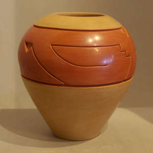 Red and tan jar carved with a geometricdesign