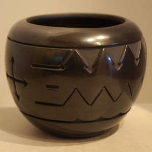 Geometric designs carved into a black jar