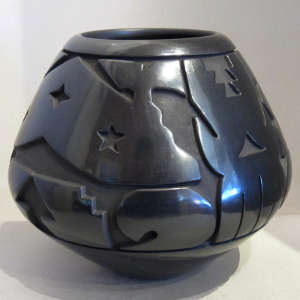 Geometric designs carved into a black jar