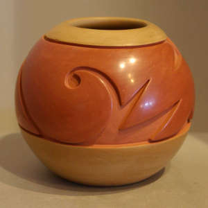 Tan and red carved jar