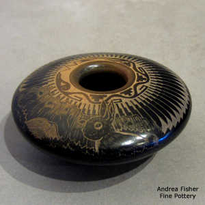 Sgraffito rabbit, feather, nature, avanyu and geometric design on a black seed pot with a sienna rim