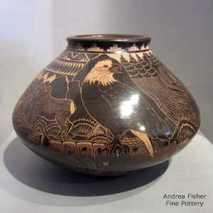 A sgraffito avanyu, feather, wildlife and geometric design on a sienna jar