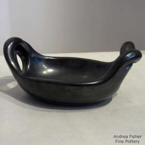Twisted handles on a polished black bowl
