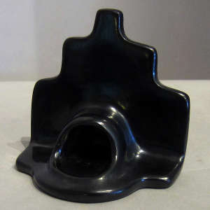 A kiva step wall above a black fireplace