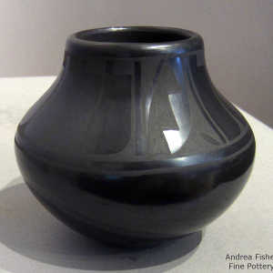 Feather and geometric design on a black on black jar