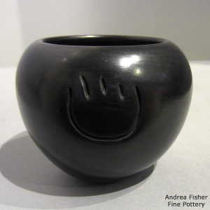 Bear paw imprint carved into a black jar