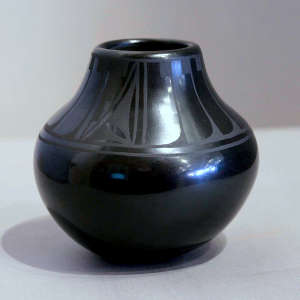 Feather, kiva step and geometric design on a black on black jar