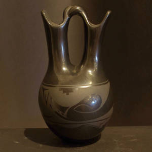 A twisted handle and an avanyu design on a black on black wedding vase