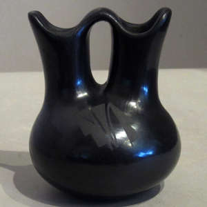 Geometric designs on a polished black on black wedding vase