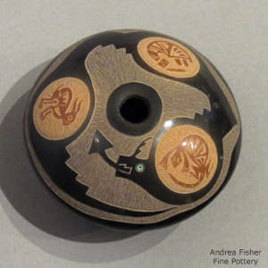 Sgraffito avanyu, medallion and geometric design on a black seed pot with sienna spots