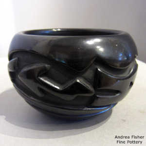 Avanyu design carved into a black jar