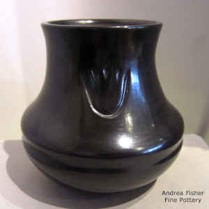 Bear paw imprints on a black jar