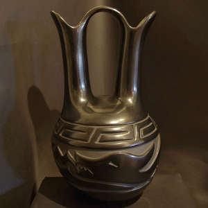 Avanyu and geometric designs carved into a black wedding vase