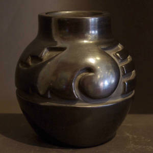 Geometric designs carved into a polished black jar