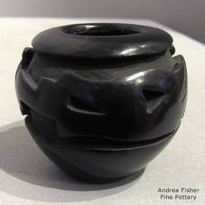 Avanyu design carved into a black jar