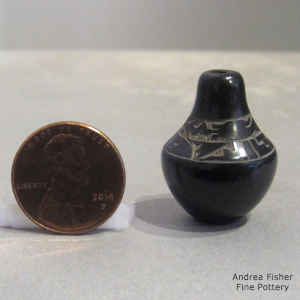 Miniature black seed pot with sgraffito avanyu and geometric design