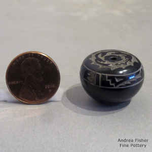 Miniature black seed pot with sgraffito avanyu and geometric design