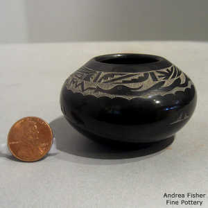 Sgraffito avanyu and geometric design on a miniature black jar