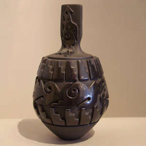 Avanyu and kiva step step design carved into a lidded black jar plus avanyu carved into lid