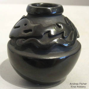 Avanyu design carved into a black jar