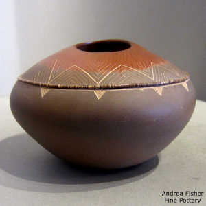 Heishi bead ring, an organic opening and a sgraffito geometric design on a polychrome jar