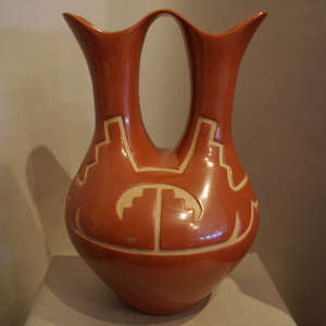 Geometric design carved into a polished red wedding vase