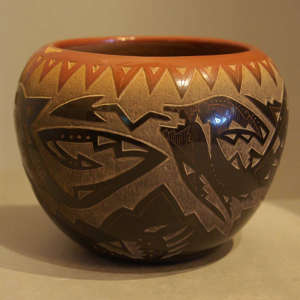 Sgraffito designs and sienna spots on a black pot