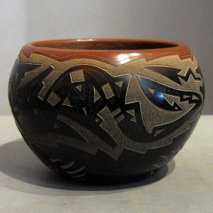 Sgraffito avanyu and geometric design and sienna spots and rim on a black pot