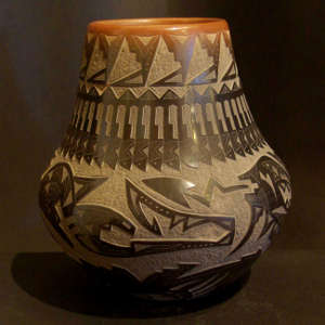 Sgraffito bear claw, feather, avanyu and geometric designs on a black pot with a sienna rim