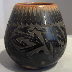 Sgraffito designs and sienna spots on a black pot