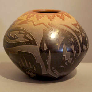 Sgraffito avanyu, bear paws and geometric design on a black jar with sienna rim and spots