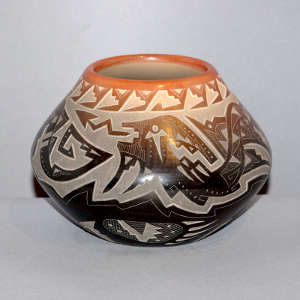 Sgraffito avanyu, bear paw and geometric design on a black bowl wiath a sienna rim