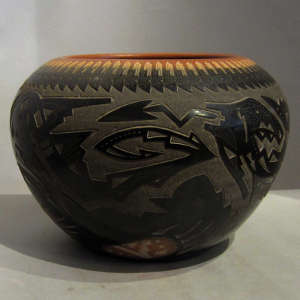 Sgraffito designs and sienna spots on a black pot