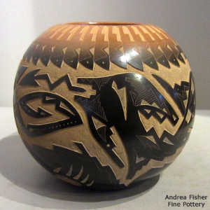 Sgraffito avanyu and geometric design on a black jar with a sienna rim and sienna spots