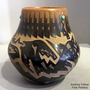 Sgraffito avanyu and geometric design on a black jar with a sienna rim and inlaid stones