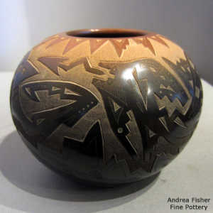 Sgraffito bear, bear paws, heart line, feather and geometric design on a black jar with a sienna rim and sienna spots