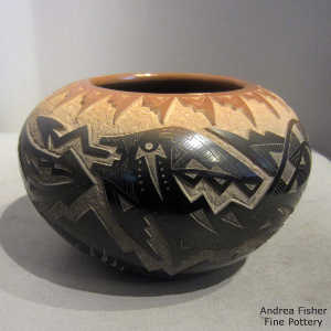 Sgraffito avanyu, bear paw and geometric design on a black jar with a sienna rim and sienna spots