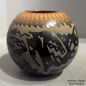 Inlaid stones and a sgraffito feather, avanyu, bear paw and geometric design on a black jar with a sienna rim