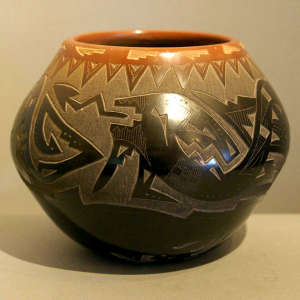 Sgraffito bear paw, avanyu and geometric design on a black jar with a sienna rim