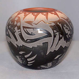 Sgraffito bear paw, avanyu and geometric design on a black jar with a sienna rim