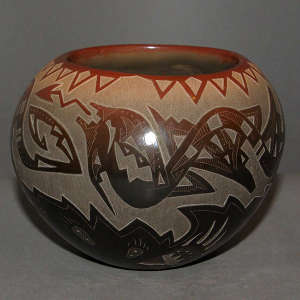 Sgraffito avanyu and geometric design on a black jar with sienna rim
