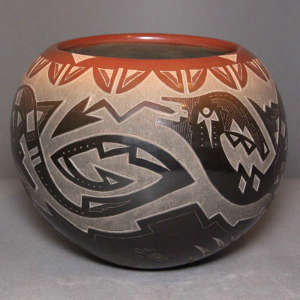 Sgraffito avanyu, bear paw and geometric design on a black jar with a sienna rim