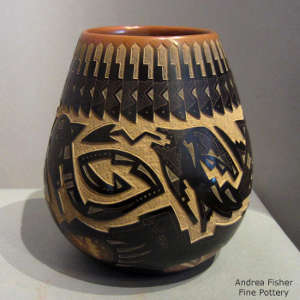 Sgraffito avanyu, bear paws, feathers and geometric design on a black jar with sienna rim and sienna spots