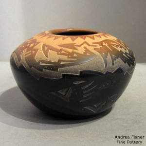 Sgraffito avanyu design in the sienna top of a black jar
