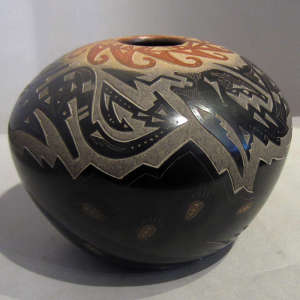 Sgraffito designs and sienna spots on a black pot